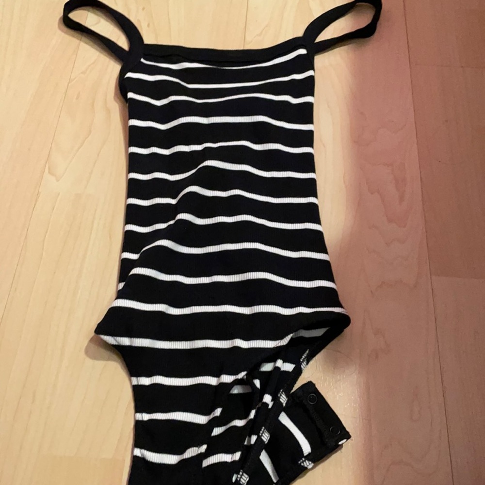 Black and white body suit with cross in back